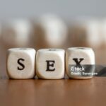 A close-up shot of the word Sex, written in wooden cubes.